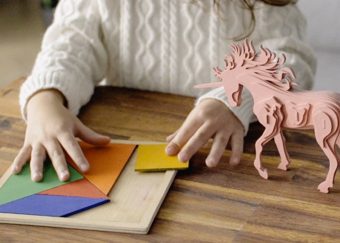 Children playing with laser-cut wooden toys created on Beamo.