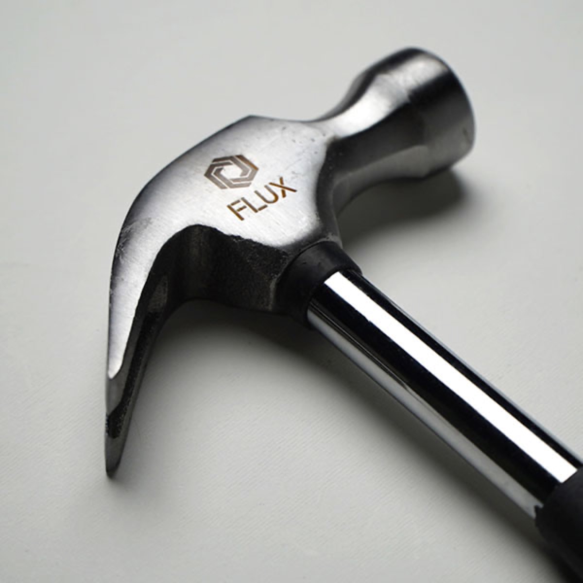 Hammer engraved with the FLUX logo.