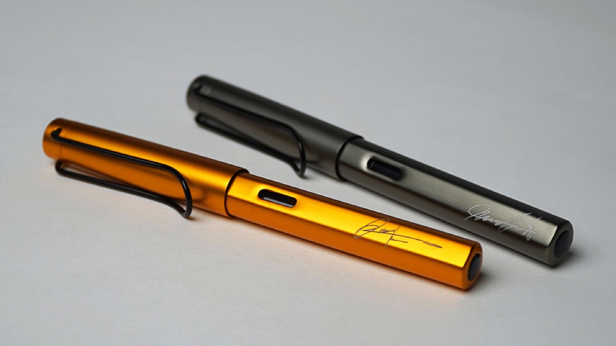 Engraved pens resting on a surface.